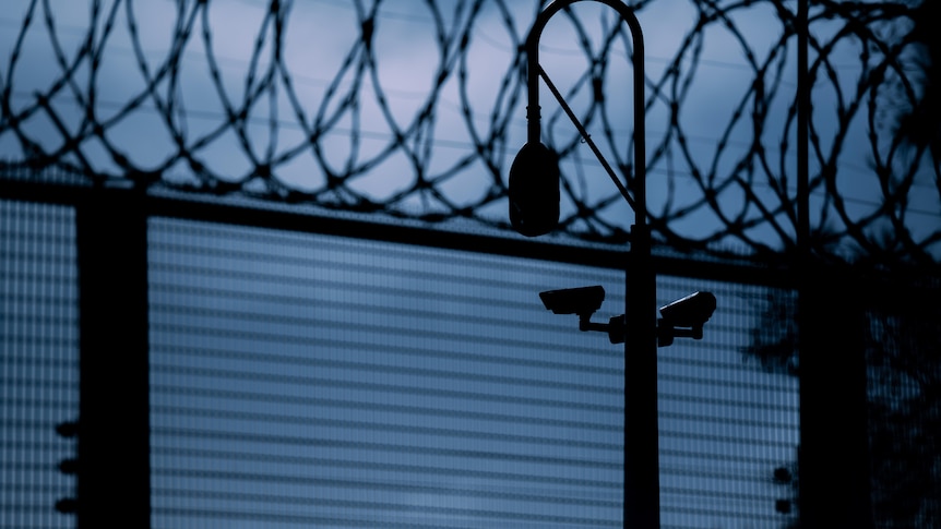 A prison fence and security camera