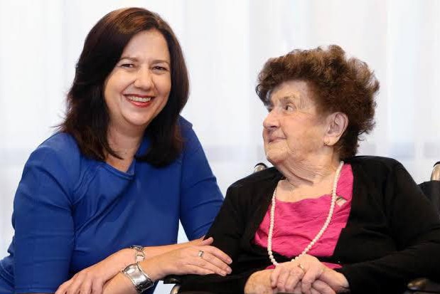 Annastacia Palaszczuk as she sits beside her 95-year-old nanna in a wheelchair.