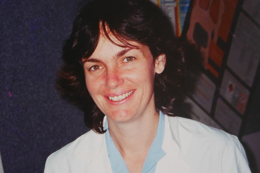 Photograph of a young woman wearing a lab coat