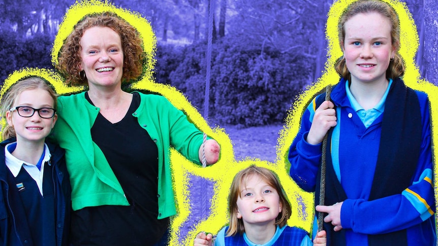 Mandy McCracken and her three daughters standing in their back garden, smiling at the camera