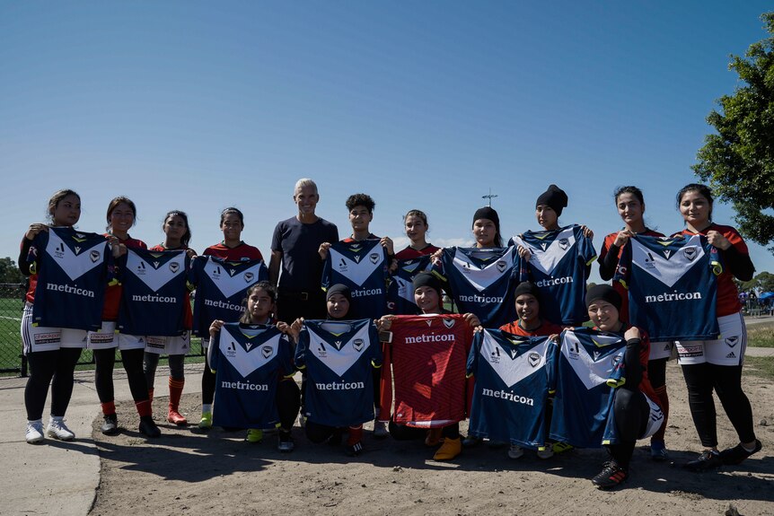 Afghan refugee women's team group photo with their jerseys