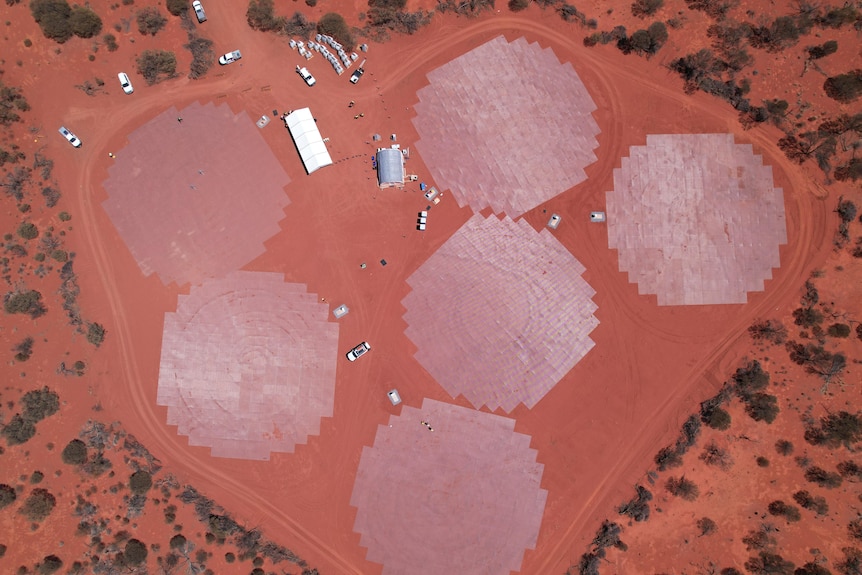 An aerial drone shot of a facility being built in the WA outback, with lots of red dirt surrounding. 
