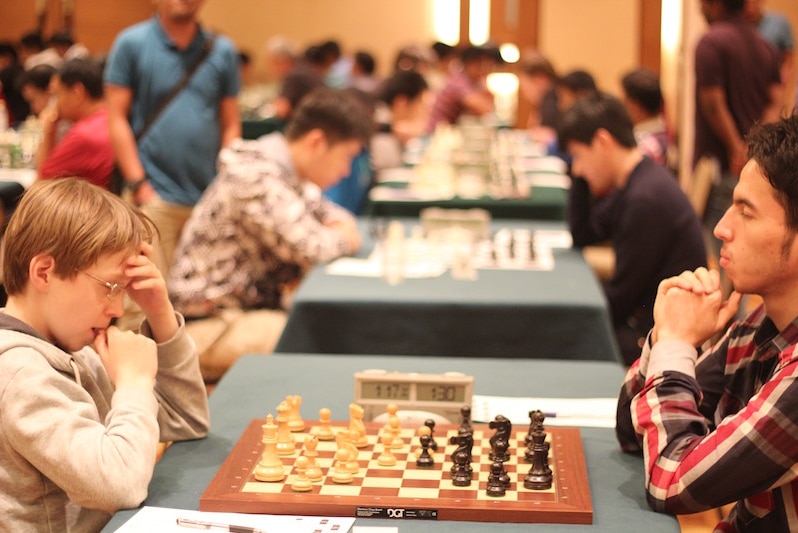 Anton Smirnov, 14, meets GM Jahonghir Vakhidov, 20, at the Malaysian Chess Festival Open 2015.