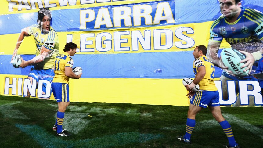 Thanks for the memories ... Nathan Hindmarsh and Luke Burt prepare to run through the banner