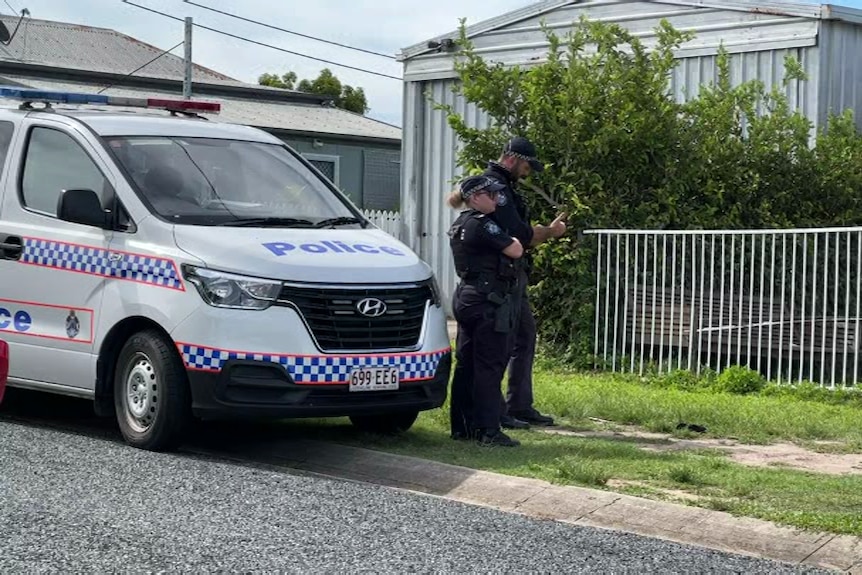 Police officers stand outside house linked to death of child in North Mackay