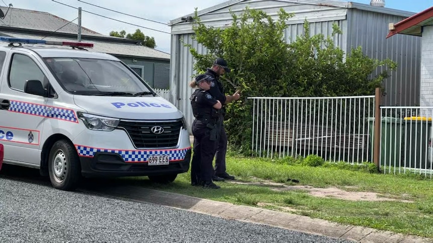 Police officers stand outside house linked to death of child in North Mackay