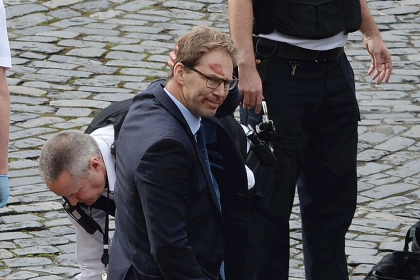 Conservative MP Tobias Ellwood with blood on his forehead