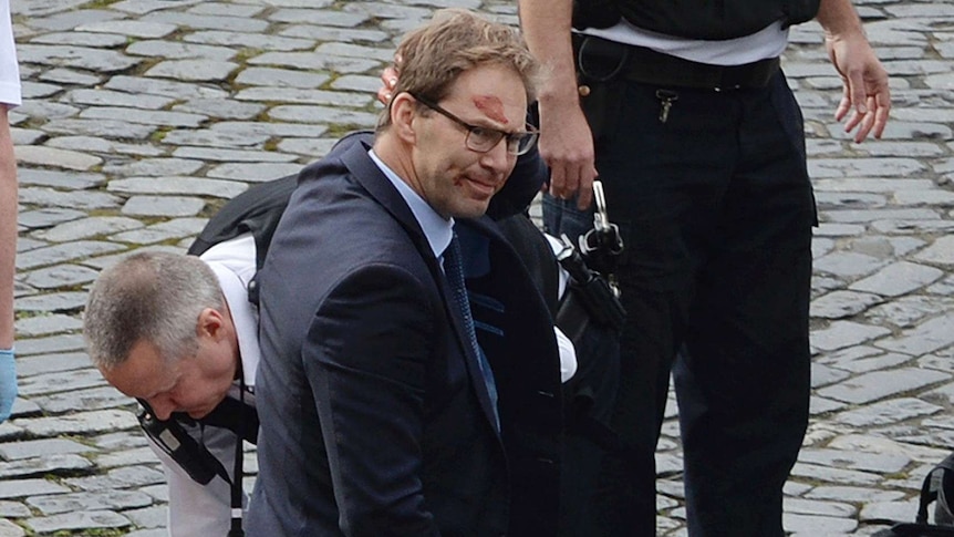 Conservative MP Tobias Ellwood with blood on his forehead