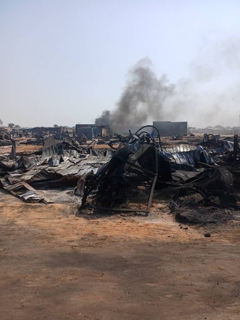 cars and buildings left in a twisted and charred wreck