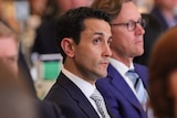 Opposition Leader David Crisafulli listening among crowd at Queensland Resources Council lunch