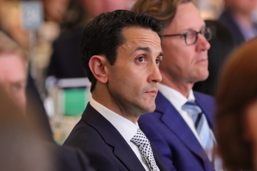 Opposition Leader David Crisafulli listening among crowd at Queensland Resources Council lunch