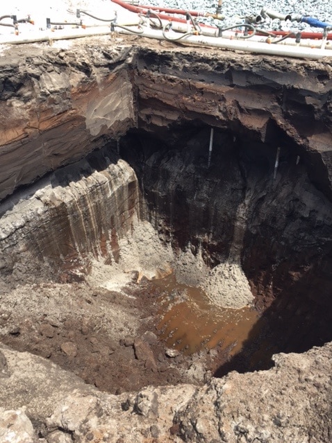 Soil pit with groundwater in the bottom on Gold Coast Airport construction site