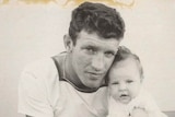 a black and white image of a young man with his baby daughter
