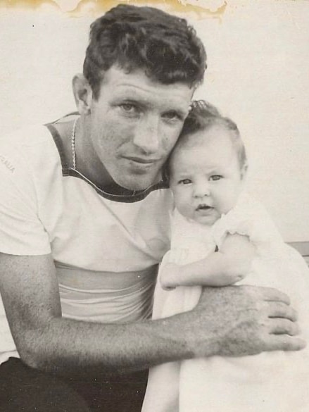 a black and white image of a young man with his baby daughter