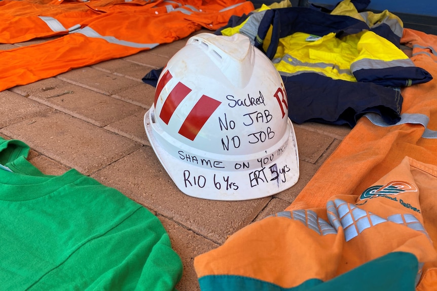 A hard hat and hi-vis clothes laying on bricks