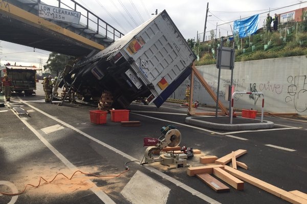 Fire crews make a wooden brace to hold the truck in position