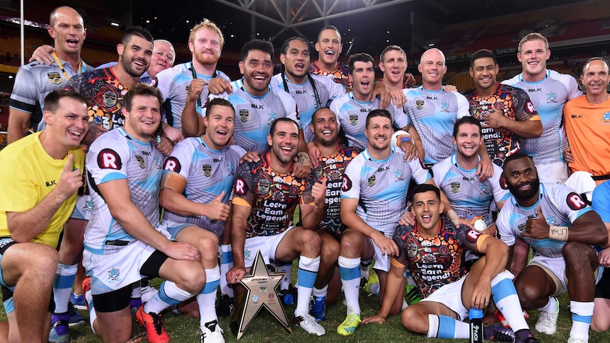 World All Stars team poses with Arthur Beetson Trophy after win over Indigenous All Stars.