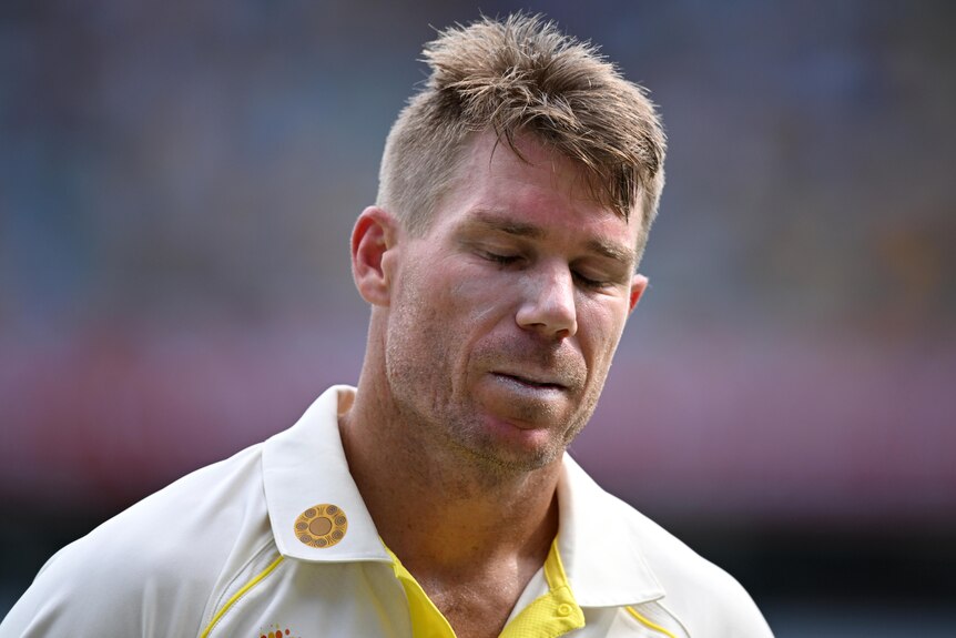 An Australian batter walks off the field after being dismissed in the first men's Ashes Test at the Gabba.