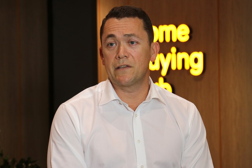 A head and shoulders shot of Bankwest general manager personal banking Scott Spittle speaking at a media conference indoors.