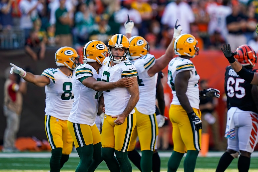 Mason Crosby is hugged by his teammates