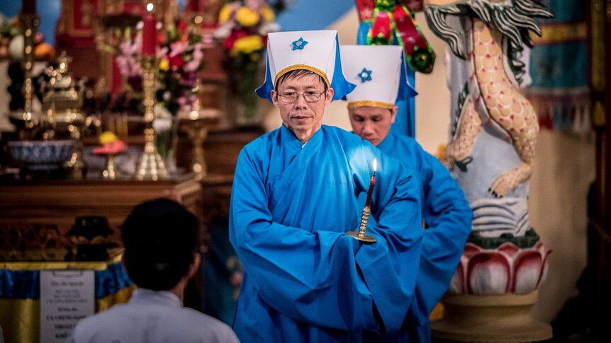 Priest wearing traditional blue robes are seen during a Cao Dai service. Photo taken on August 16 2019