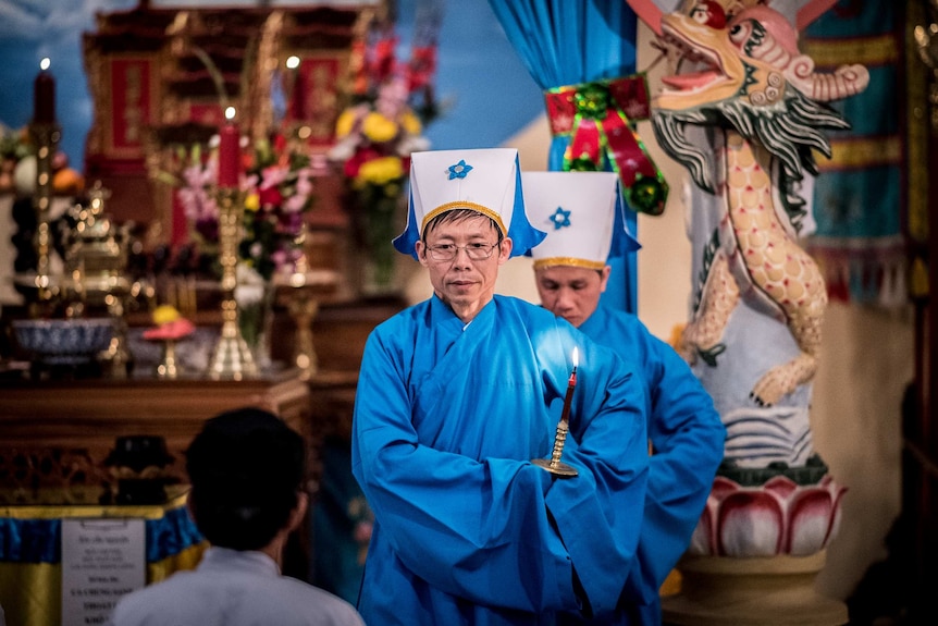 Priest wearing traditional blue robes are seen during a Cao Dai service. Photo taken on August 16 2019