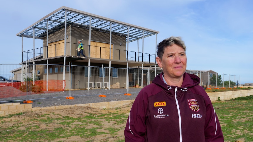 Kalbarri woman Claire Stringer standing outside her cyclone-damaged home in Kalbarri. 