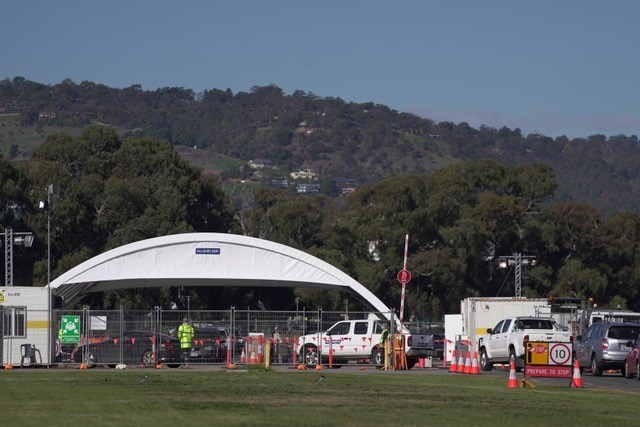 A large round marquee with cars waiting in front