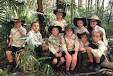 A group of students from the Nature School sitting in the bush.