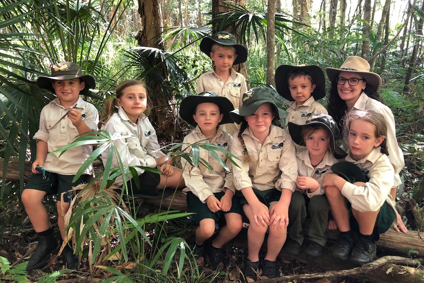 A group of students from the Nature School sitting in the bush.