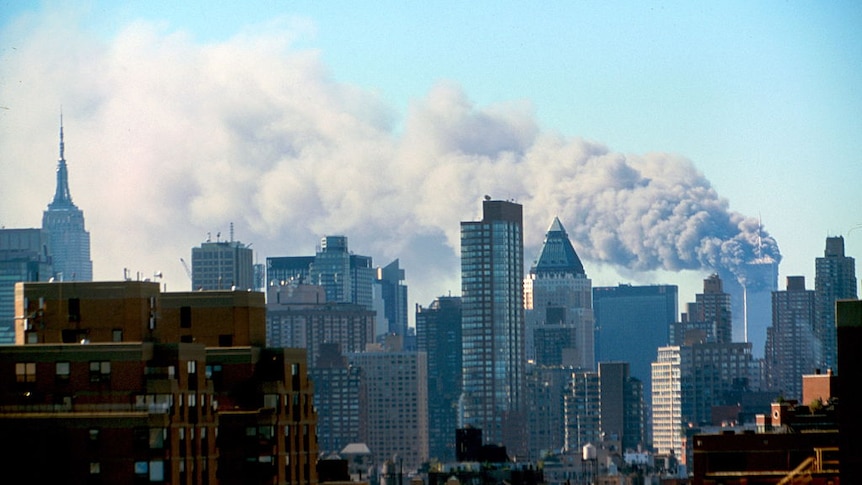 Colour photograph of the Manhattan skyline following the terrorist attacks - smoke billowing from the World Trade Centre