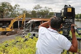 ABC cameraman Gordon Fuad films the demolition of ABC Toowong