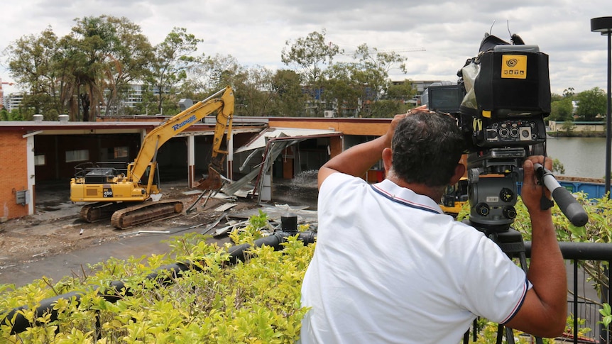 ABC cameraman Gordon Fuad films the demolition of ABC Toowong