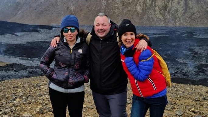 Three people pose against an Icelandic backdrop.