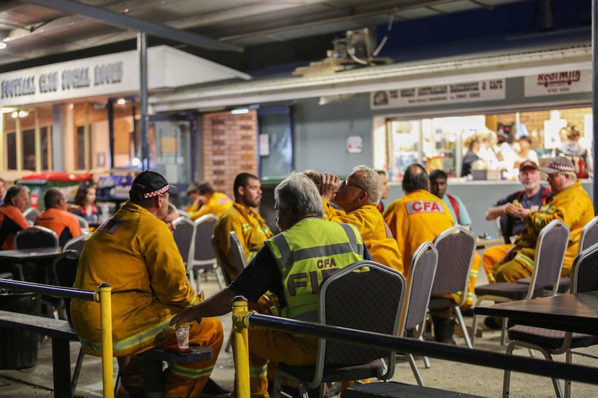 CFA crews sit at tables having breakfast and coffee.