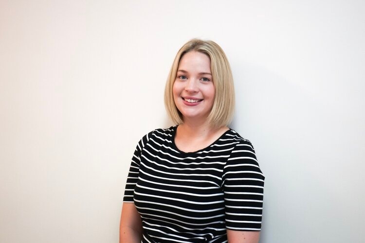 Head shot of blonde Gold Coast clinical psychologist Cassie Lavell, wearing a black top