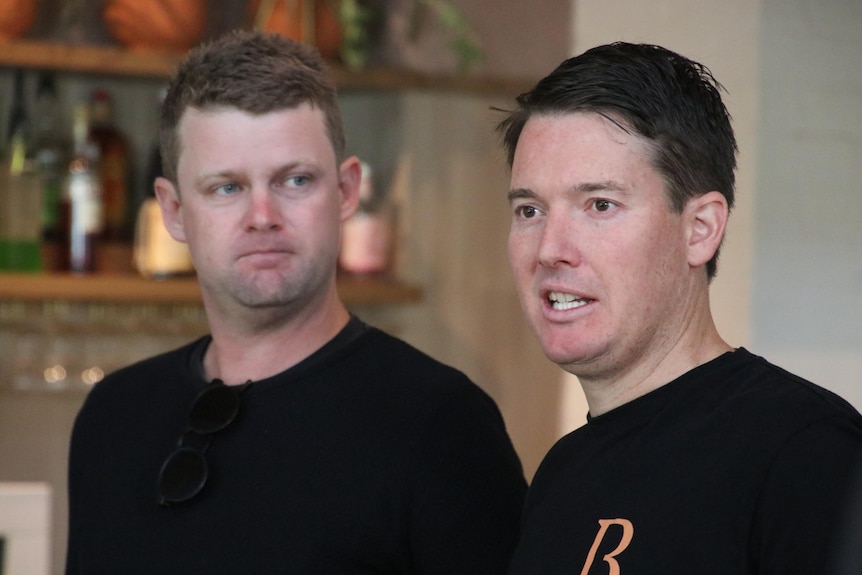 Drew Flanagan and Ross Drennan wearing black t-shirts pictured in a pub