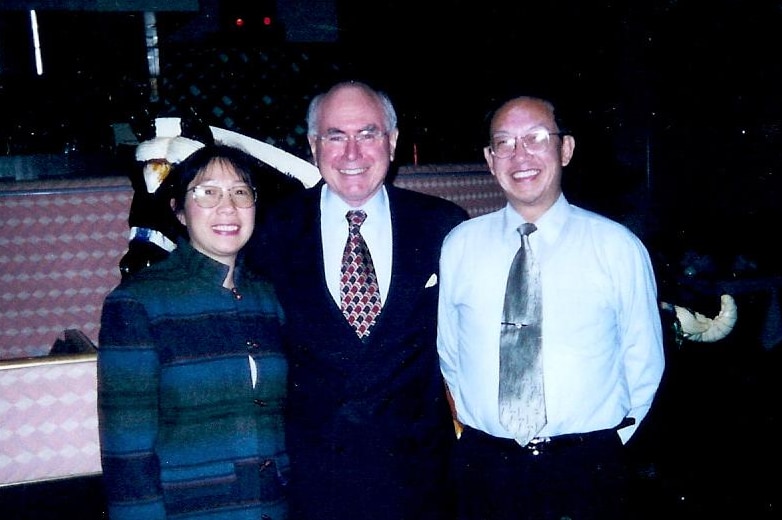 Two man and a woman smiling in a Canberra resturant