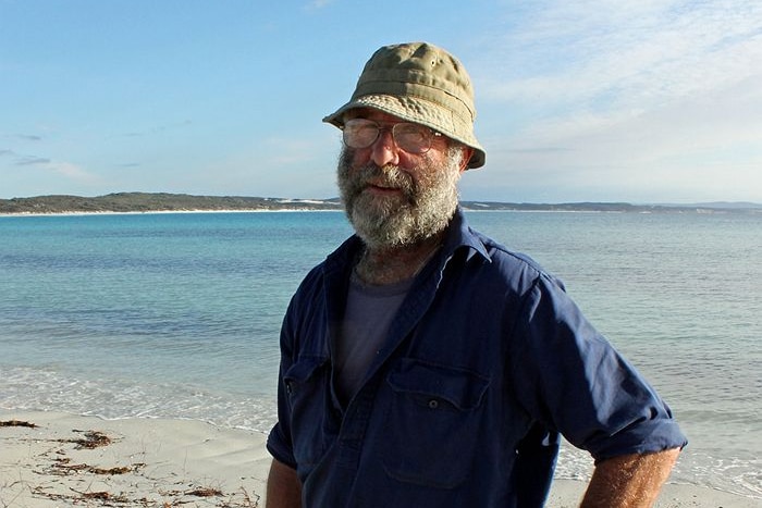 a man with a hat near the beach