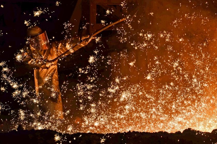A steel-worker is pictured at a furnace at the plant of German steel company Salzgitter AG