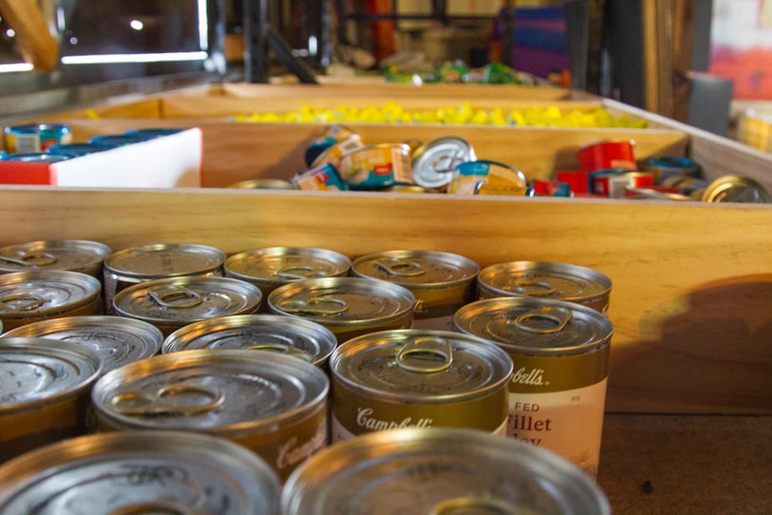 Tinned food ready to be packed into sacks.