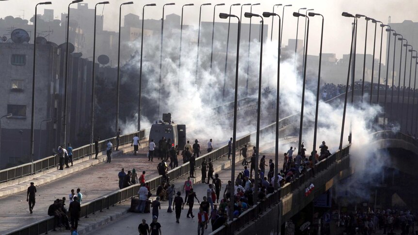 Muslim Brotherhood and Mohammed Morsi supporters flee from tear gas and rubber bullets.