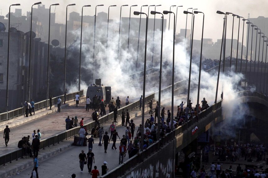 Muslim Brotherhood and Mohammed Morsi supporters flee from tear gas and rubber bullets.
