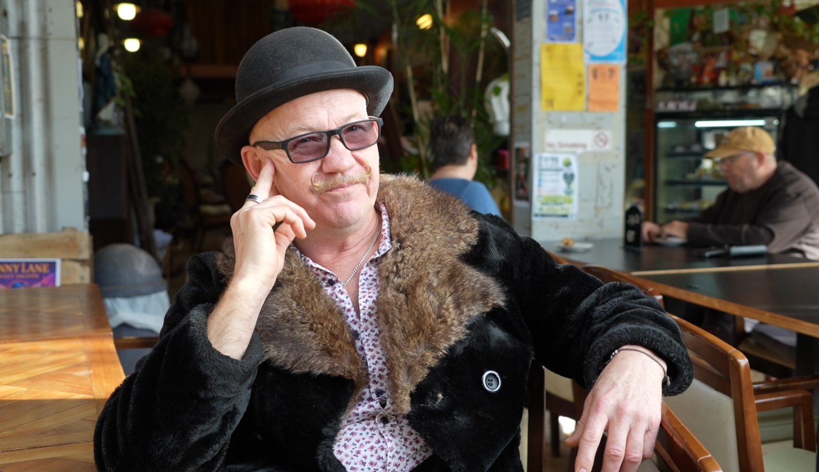 Cafe owner battles high sponsorship costs as government vows to cut migration