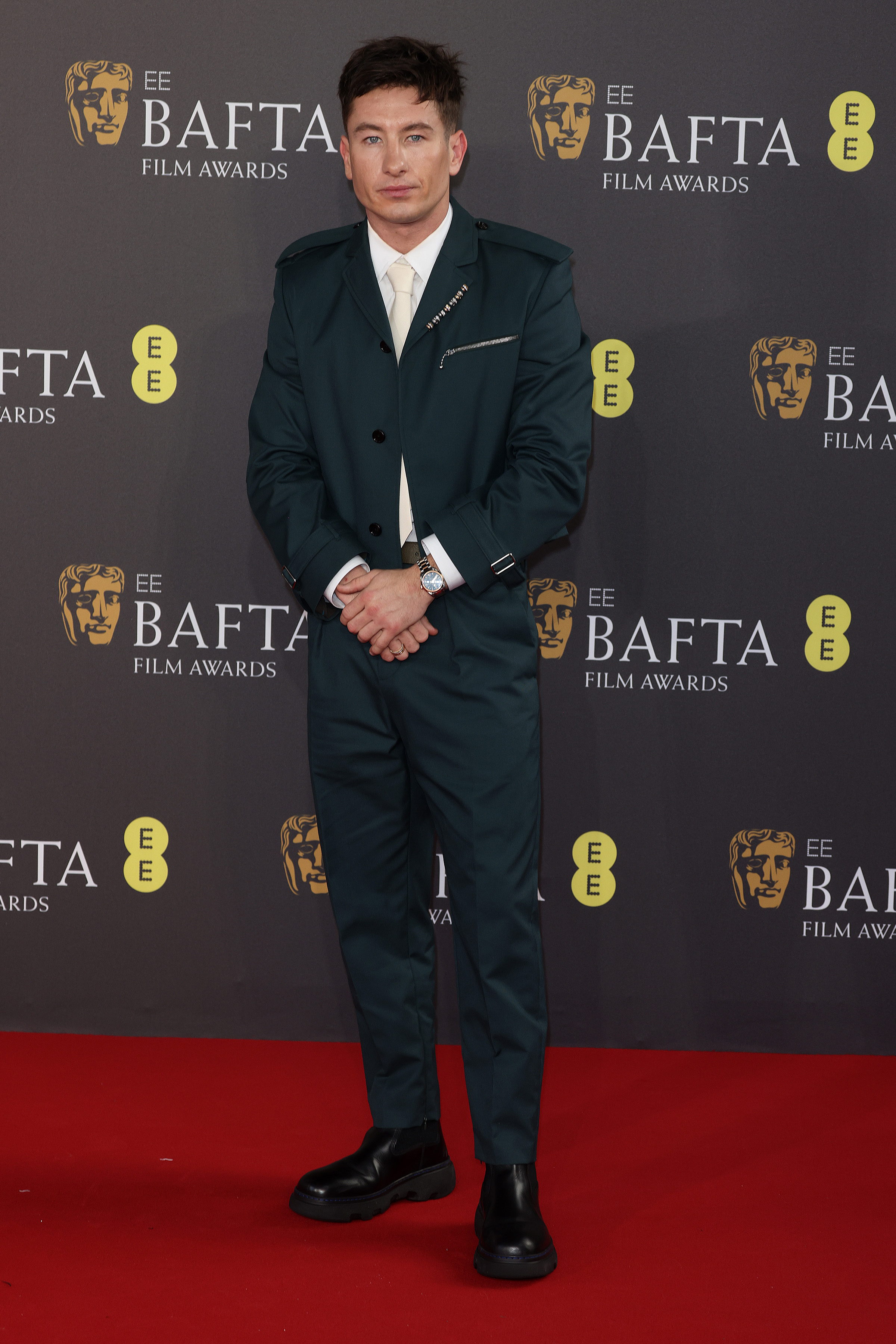 Actor Barry Keoghan in a very dark green suit on the red carpet