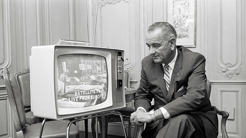 Lyndon Johnson watches television in a living room