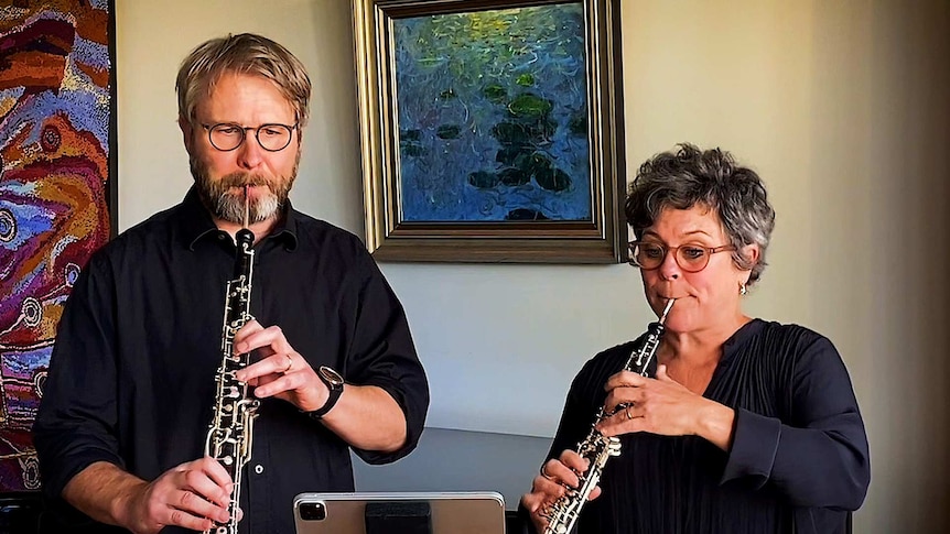 Two musicians playing oboe and cor anglais at home.