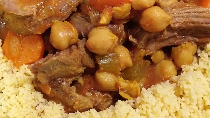 a curry with meat and chickpeas on a bed of couscous