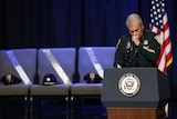 Sheriff Sid Gautreaux holds his hand to his mouth during his speech at a memorial for police officers killed in Baton Rouge.