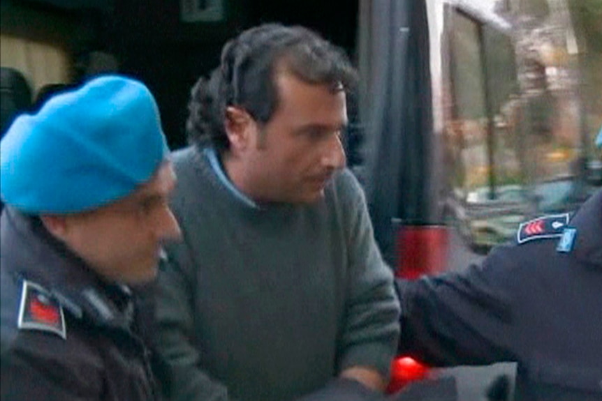 Captain Francesco Schettino of cruise ship Costa Concordia is escorted into a prison by police officers at Grosseto